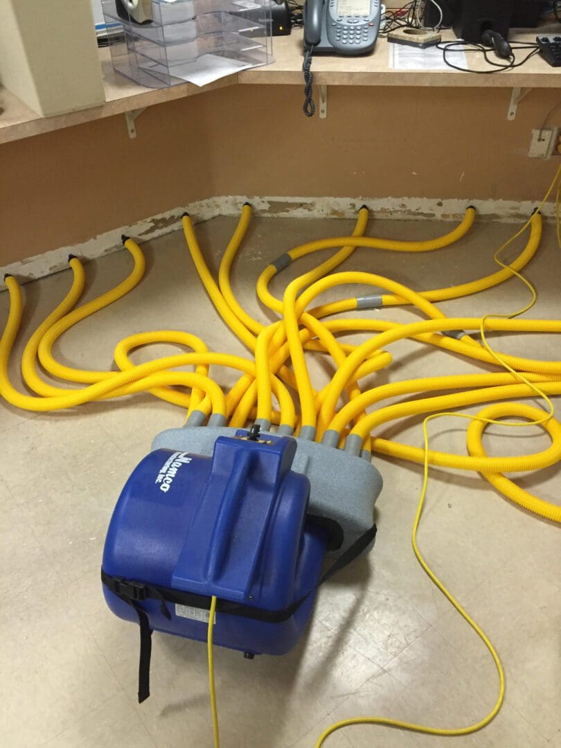 A bunch of yellow wires are connected to the floor.