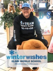 Person sitting on large stuffed animal.