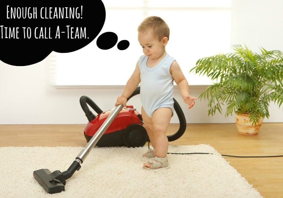 A baby is playing with a vacuum cleaner.